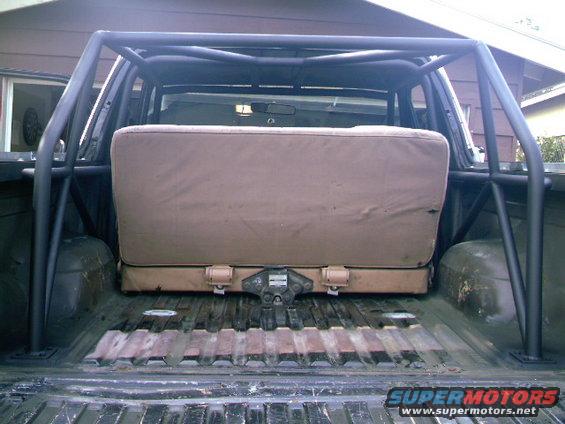 Roll cage and rear seat installed in the bed of a pickup truck