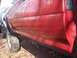 1995 Toyota Tacoma - The side panel and fender flare of a red pickup truck are shown in this close-up view.