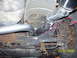 1994 Ford Probe - Underside view of a car's exhaust system, showing pipes and suspension components.