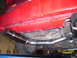 1994 Ford Probe - A custom exhaust system is installed on the rear underside of a red vehicle.