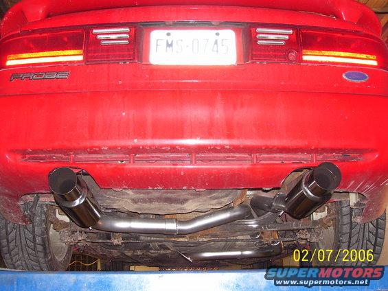 Red 1994 Ford Probe rear with dual exhaust pipes and license plate FMS-0745