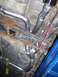 1994 Ford Probe - Custom exhaust system installation visible on the underside of a vehicle.