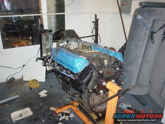 Blue valve covers on a V8 engine on an engine stand
