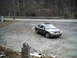 2001 Ford Taurus - This silver sedan, identified as a 2001 Ford Taurus, is parked in a gravel lot with a sunroof visible.