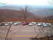 1994 Ford Probe - Cars parked at a scenic overlook during autumn, with mountains in the distance.