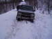 2000 Chevrolet Tahoe - A gray Chevrolet Tahoe is stuck in a snowy area, with another vehicle visible behind it.