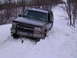 2000 Chevrolet Tahoe - This Chevrolet Tahoe is stuck in the snow, with an axe lodged in front of it on a winter day.