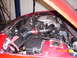 1994 Ford Probe - The engine bay of a red car features an aftermarket air intake system and a visible fuse box, with a date stamp of 02/09/2006.