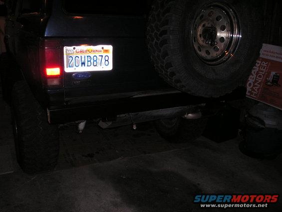 Dark SUV rear with California license plate 2CWB878 and a spare tire