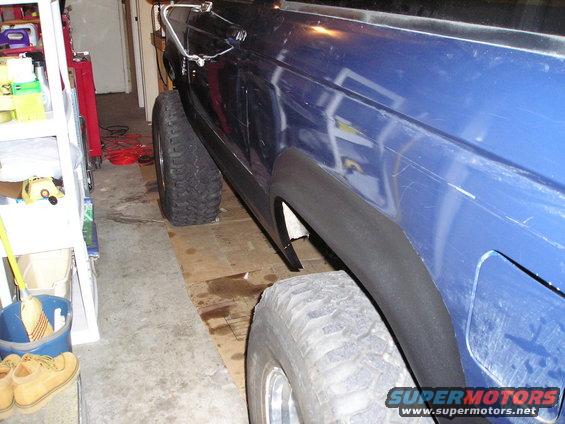 Blue SUV side view showing large tires and fender flares
