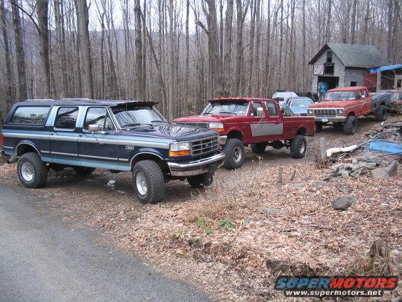 Blue Ford Bronco SUV, 3q-front view, lifted with off-road tires