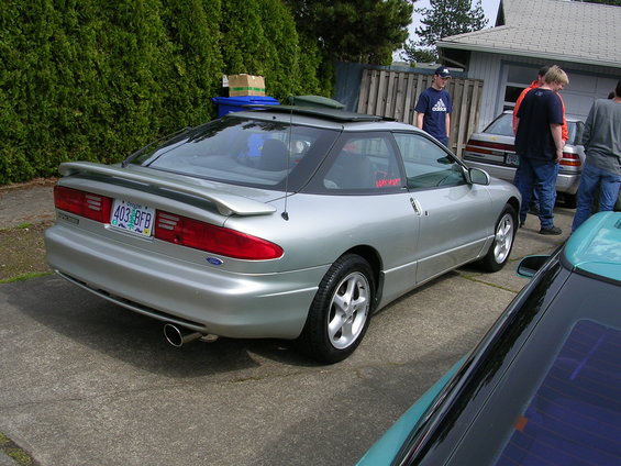 Silver 1996 Ford Probe with a rear spoiler and a sunroof, parked on a driveway