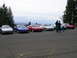 1996 Ford Probe - A group of Ford Probes are parked in a lot, with several people gathered around.
