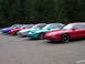 1996 Ford Probe - A line of Ford Probe coupes, including a red one in the foreground, are parked in a lot.