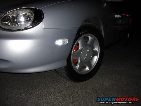 Silver 1999 Ford Taurus front wheel and headlight
