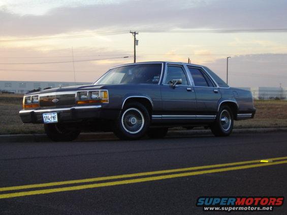 Dark blue 1988 Ford Crown Victoria LTD parked on the side of the road