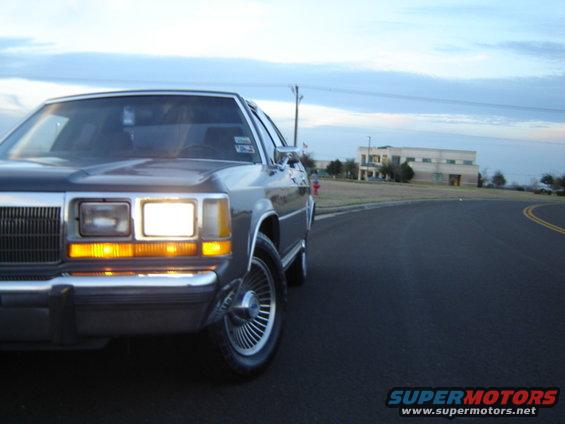 1988 Ford Crown Victoria LTD parked on a road with a building in the background