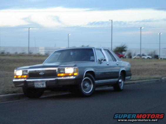 Gray 1988 Ford Crown Victoria parked on the side of the road