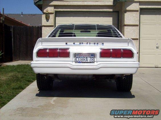 Rear view of a white 1978 Ford Mustang II Cobra with louvers on the rear window and a California license plate that reads COBRA 78