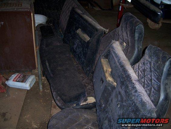 pile of dark quilted car door panels with wood grain trim