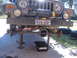2004 Jeep Wrangler - Front end of a 2004 Jeep Wrangler lifted for suspension repair, a winch mounted on the bumper.