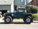 1994 Jeep YJ - Side view of a modified 1994 Jeep YJ Wrangler with large off-road tires.