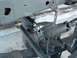 1994 Jeep YJ - A close-up view of the steering stabilizer and differential assembly on a vehicle.