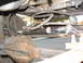 1994 Jeep YJ - Close-up view of a steering stabilizer assembly on the underside of a vehicle.