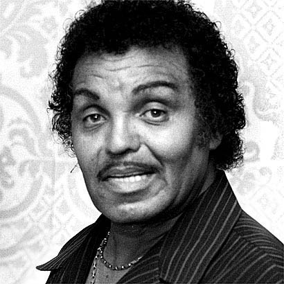 Portrait of a man with curly hair and a mustache