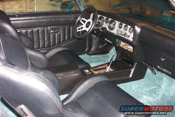 1979 Pontiac Trans Am interior showing black bucket seats, dashboard with gauges, and center console