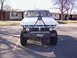 1978 Ford Bronco - This 1970s Ford pickup truck features a heavy-duty custom front bumper and a unique triangular frame structure attached to the hood.