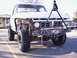 1978 Ford Bronco - This pickup truck has a custom front end and tow bar, with another truck visible in the background.