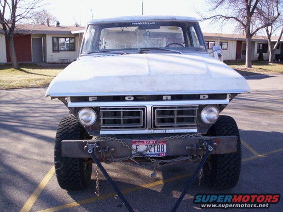 White Ford F-Series truck front view, custom bumper, chains, Idaho license plate E 72188