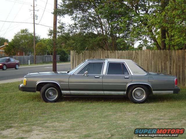 Gray 1988 Ford Crown Victoria LTD parked on grass, side view