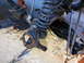 1984 Ford Bronco - The front suspension components of a vehicle are shown, with the wheel hub removed and the coil spring visible.