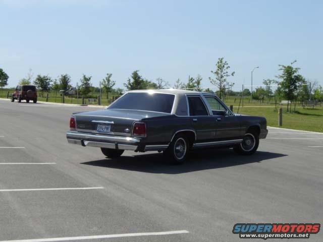 Dark gray 1988 Ford Crown Victoria LTD sedan, rear 3/4 view, parked in a lot