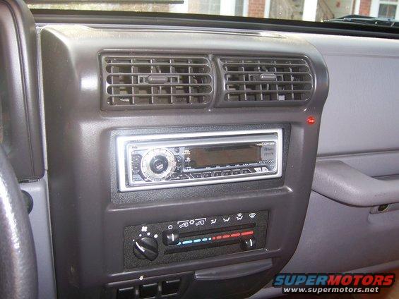 Dashboard of a Jeep Wrangler with aftermarket stereo and climate controls