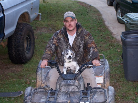 Man and dog on camouflage ATV