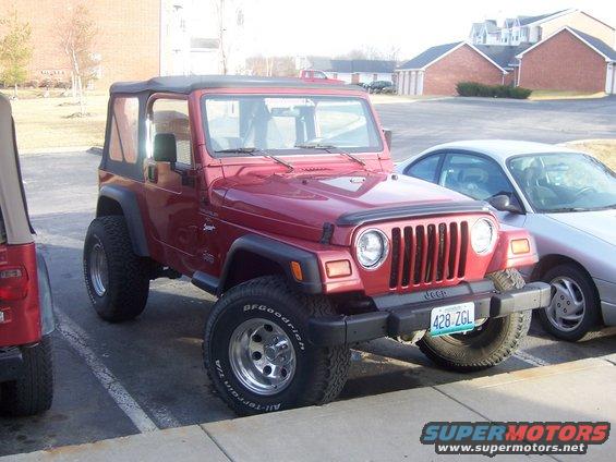 Red 1998 Jeep TJ parked next to a silver sedan