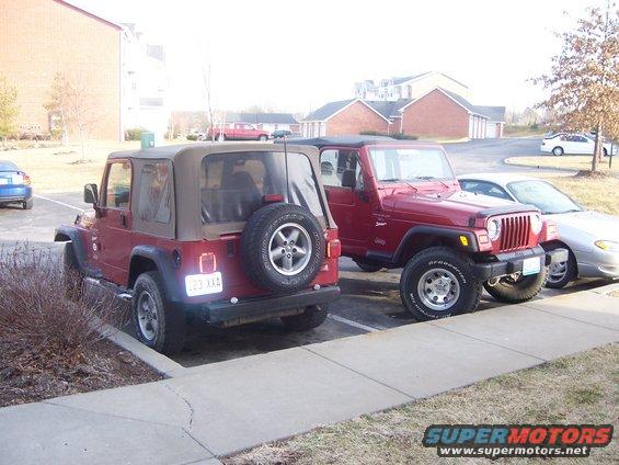 Two red Jeep Wranglers parked in a lot. The one on the left is facing away, the one on the right is facing forward