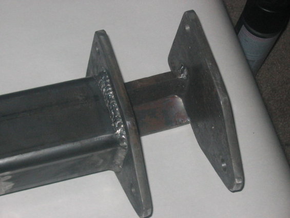 Close-up of a welded steel bracket with two mounting plates