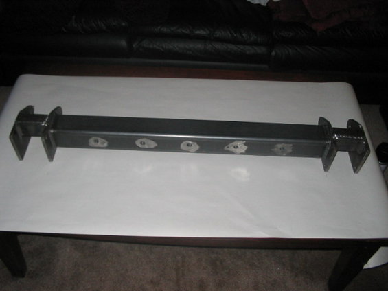 Metal suspension component with six circular cutouts and bracketed ends