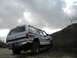 1994 Ford C-350 (Centurion Conversions) - This 1994 Ford C-350 (Centurion Conversions) is seen in a rural, off-road setting under a cloudy sky.