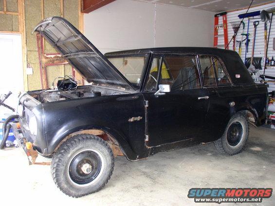 Black 1967 International Scout 800 with hood open in garage