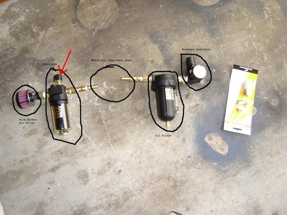 Air filter, pre-filter, and pressure regulator assembly laid out on concrete floor. Some parts are circled and labeled