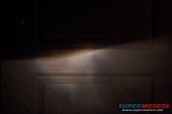 headlight beam shining on a paneled door