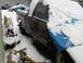 1991 Ford Bronco - A maroon truck sits partially covered in snow and a blue tarp in a snowy yard with other vehicles visible.
