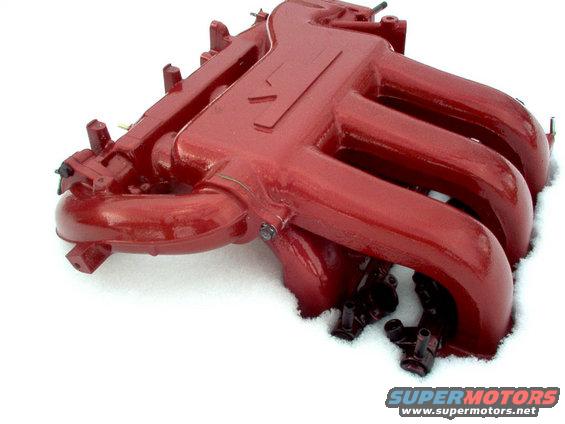 Red intake manifold with multiple runners, set against a snowy background