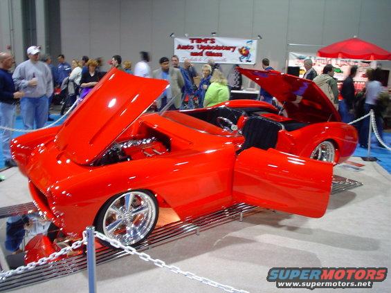 red custom convertible with hood and doors open, chrome wheels