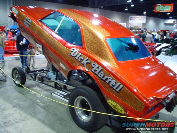 drag car with orange and wood grain paint, "Dick Harrell" lettering, and Pennzoil sticker